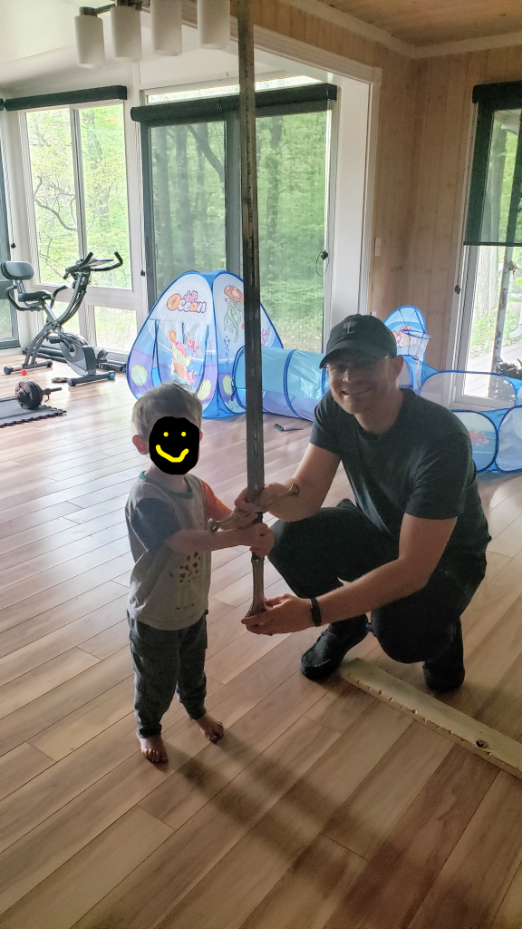 A fantasy author and his adorable son holding a replica of Anduril, the Flame of the West, Aragon's sword from The Lord of the Rings by J.R.R. Tolkien.